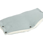 Der KraftKids Kinderwagenmuff Musselin mint ist ein hellblauer, rechteckiger, handgenähter Kinderwagenmuff mit weißem Futter und drei dunklen Knöpfen, der die Hände warm hält. Abgebildet auf weißem Hintergrund.